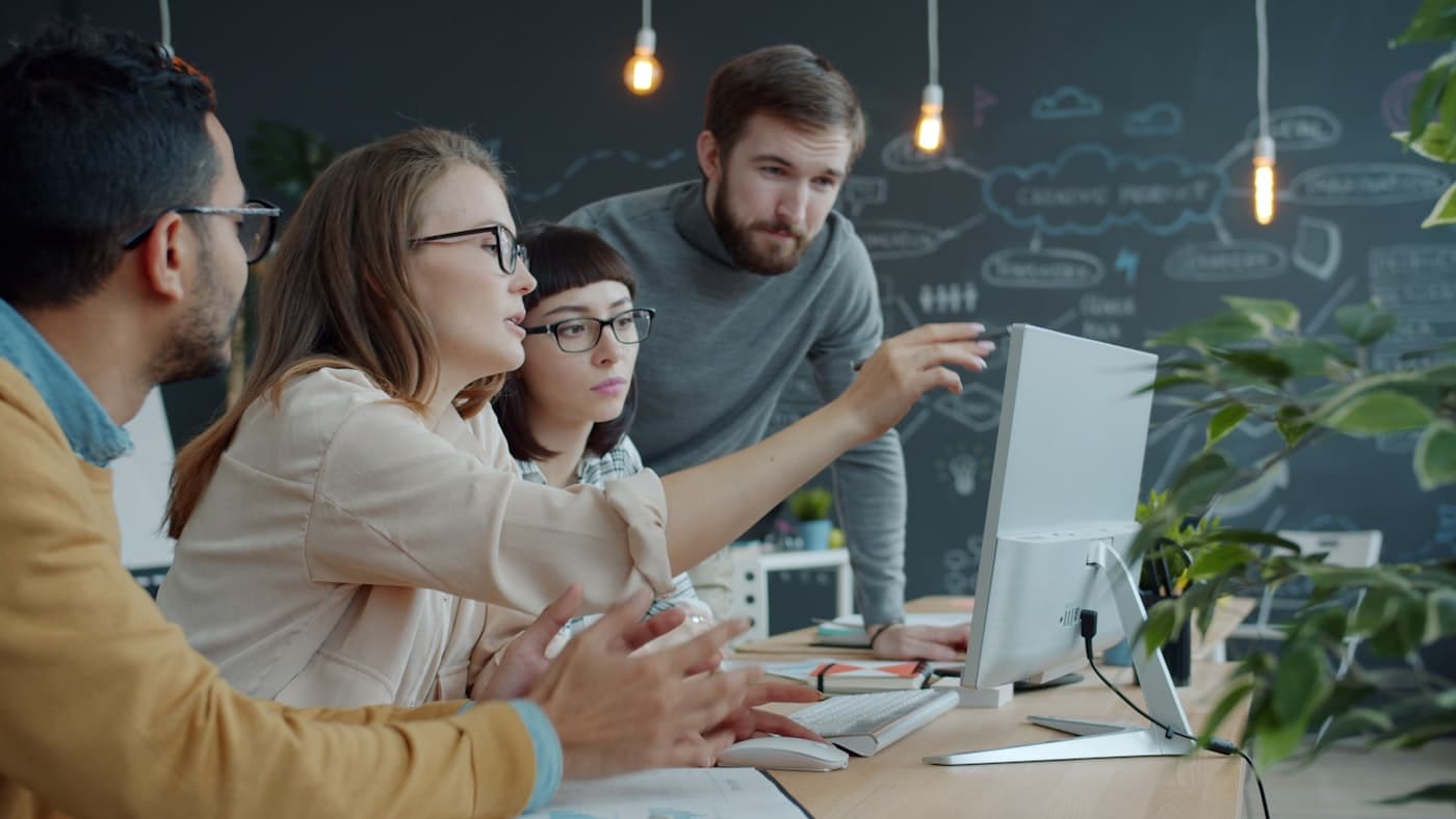 A support team reviewing resolutions together at a desk